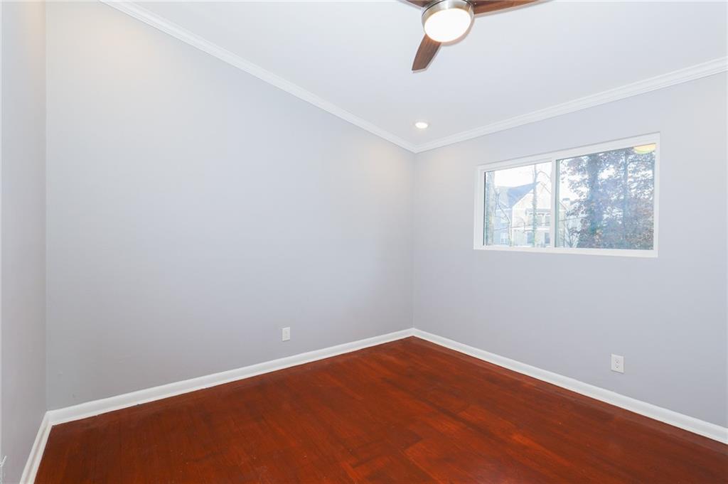 1277 Goodwin Road Northeast, Unit 1273 Atlanta, GA 30324 - Photo 13 of 19 wooden floor in an empty room with a window