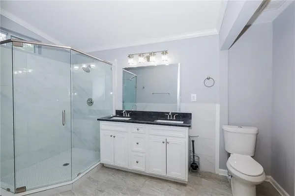 a bathroom with a granite countertop sink mirror and toilet