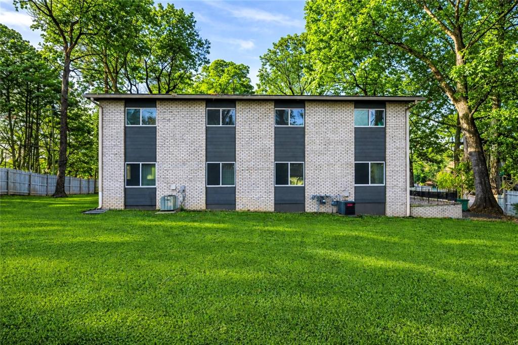 1277 Goodwin Road Northeast, Unit 1273 Atlanta, GA 30324 - Photo 17 of 18 a house with a tree in the grass