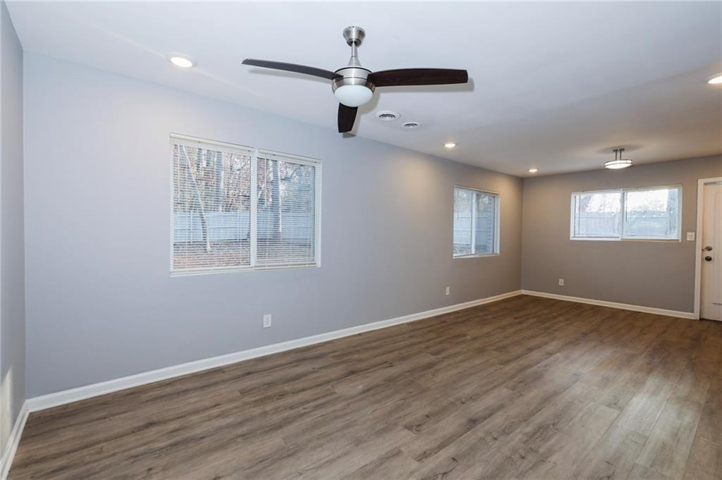 1277 Goodwin Road Northeast, Unit 1273 Atlanta, GA 30324 - Photo 2 of 18 a view of an empty room with wooden floor and a window