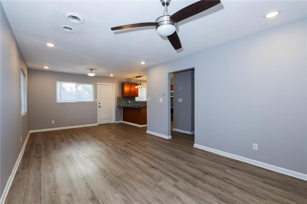 1277 Goodwin Road Northeast, Unit 1273 Atlanta, GA 30324 - Photo 3 of 18 an empty room with wooden floor cabinet and windows