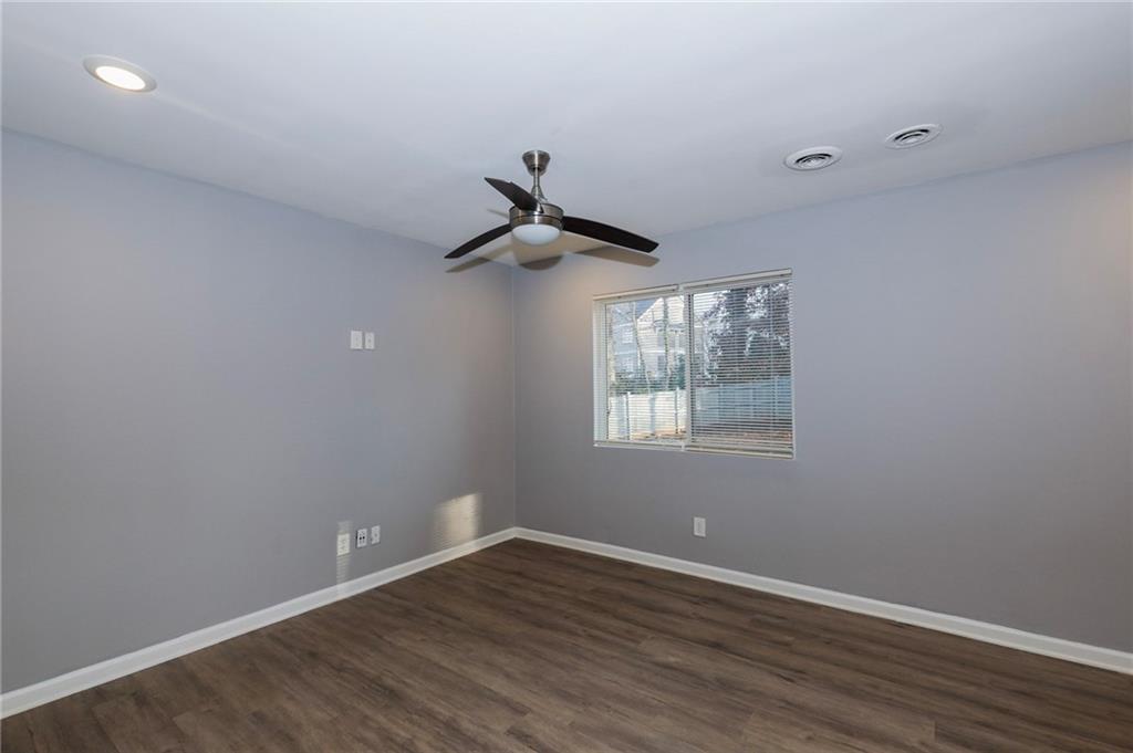 1277 Goodwin Road Northeast, Unit 1273 Atlanta, GA 30324 - Photo 7 of 18 wooden floor in an empty room with a window
