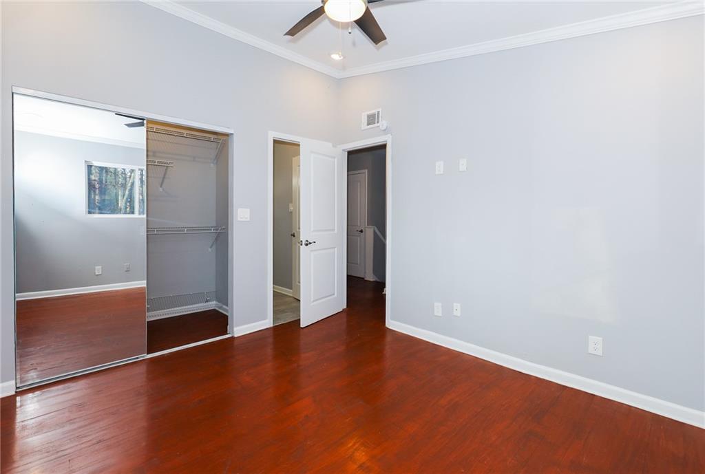 1277 Goodwin Road Northeast, Unit 1273 Atlanta, GA 30324 - Photo 10 of 19 an empty room with wooden floor and door