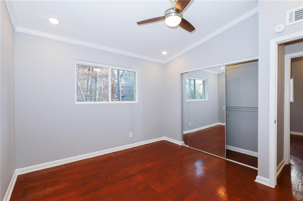 1277 Goodwin Road Northeast, Unit 1273 Atlanta, GA 30324 - Photo 10 of 18 a view of empty room with wooden floor and fan