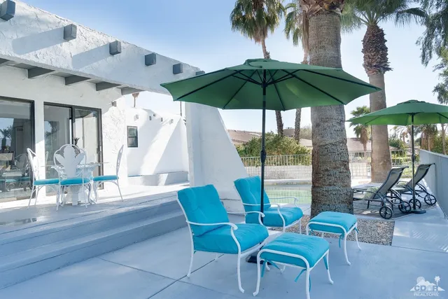 a view of living room filled with furniture and umbrella