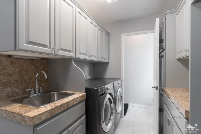 a kitchen with stainless steel appliances granite countertop a sink a refrigerator and a stove