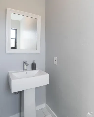 a bathroom with a sink a mirror and vanity