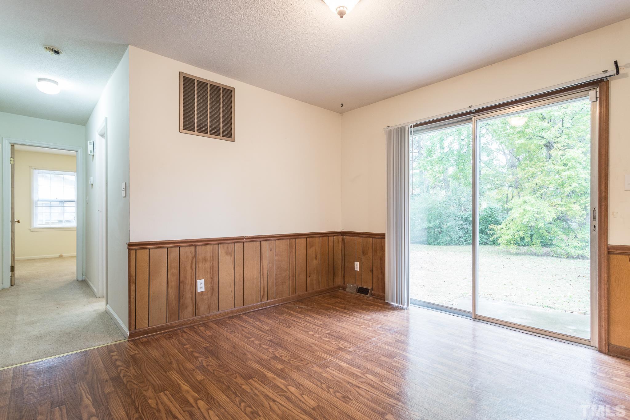 4413 Kilcullen Drive Raleigh, NC 27604 - Photo 14 of 21 a view of an empty room with wooden floor and a window