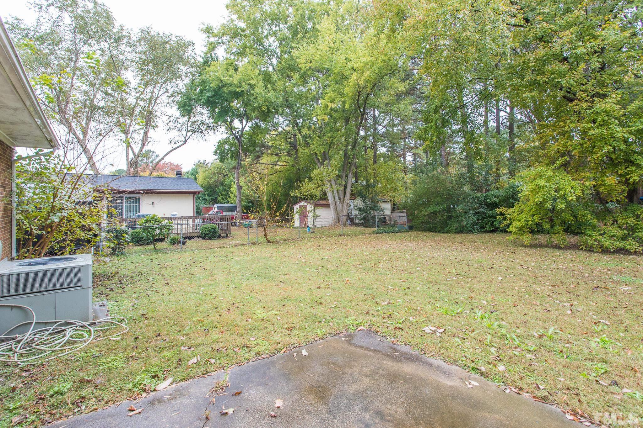 4413 Kilcullen Drive Raleigh, NC 27604 - Photo 7 of 21 a view of a yard with potted plants and large tree