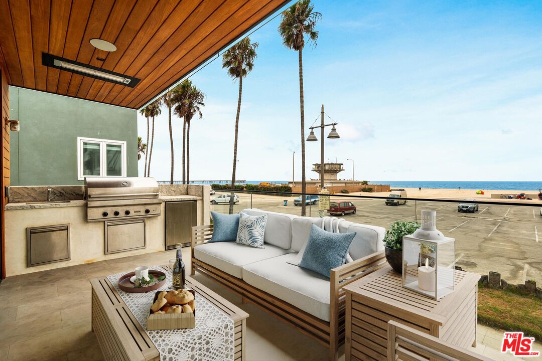 2205 Ocean Front Walk Venice, CA 90291 - Photo 11 of 30 a living room with furniture stove and kitchen view