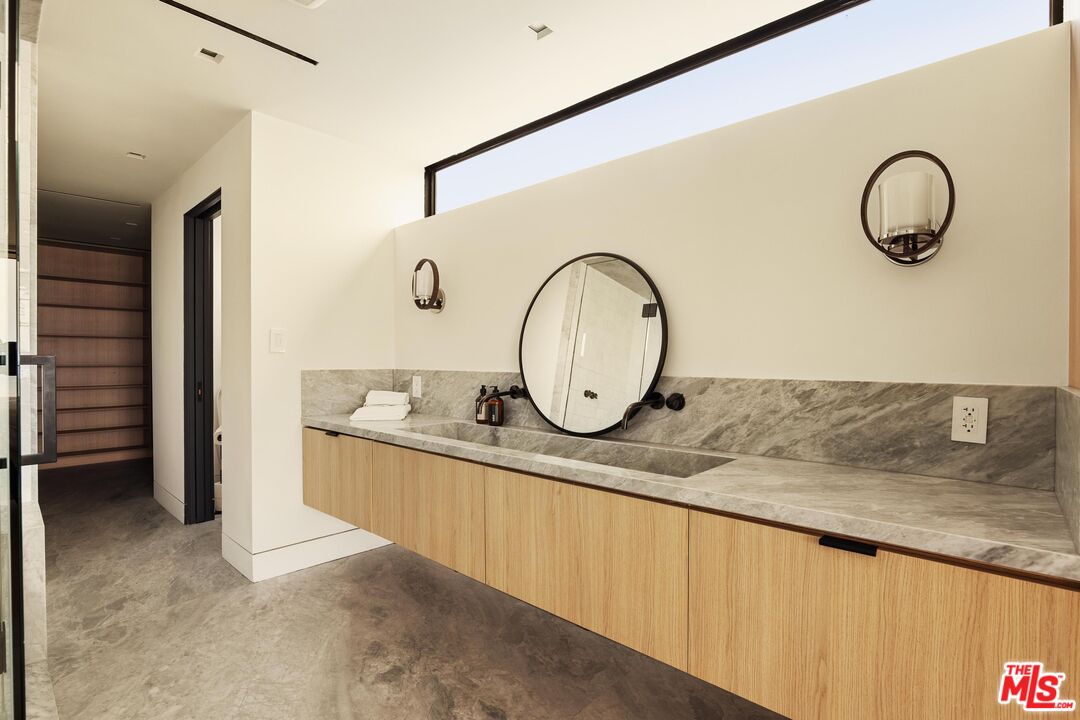 2205 Ocean Front Walk Venice, CA 90291 - Photo 18 of 30 a bathroom with a granite countertop sink a mirror and vanity