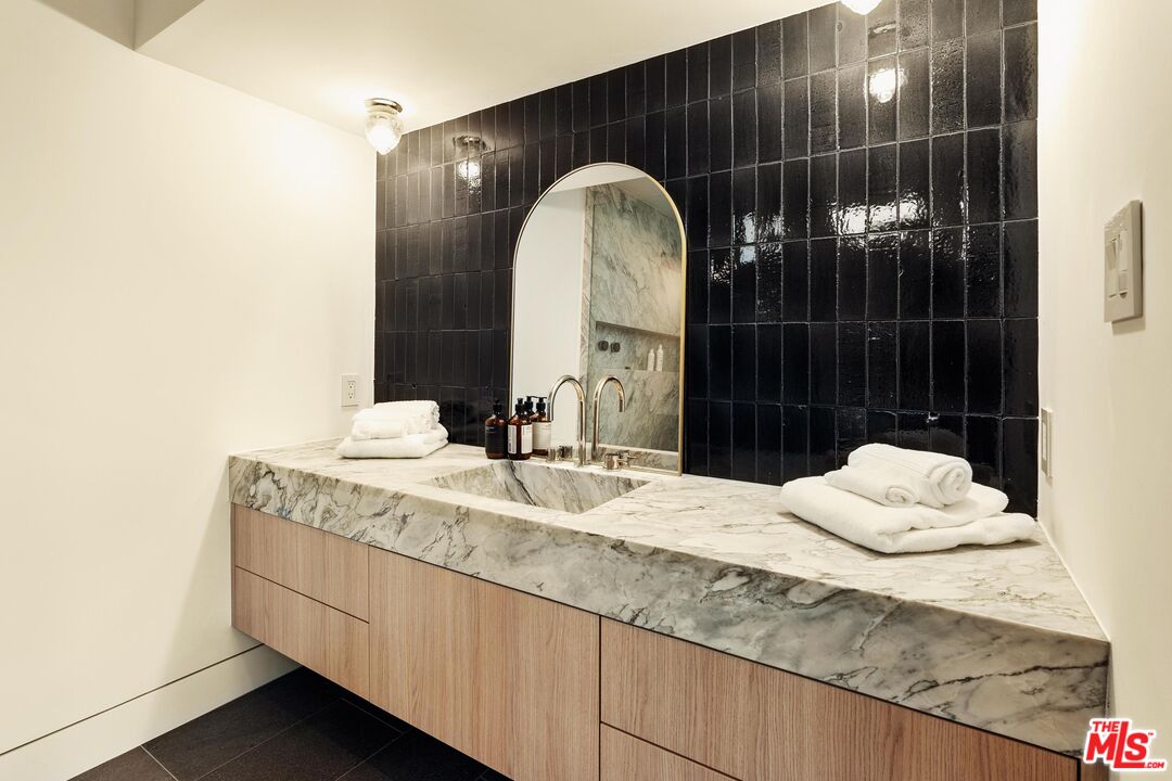 2205 Ocean Front Walk Venice, CA 90291 - Photo 21 of 30 a bathroom with a granite countertop sink a toilet and shower