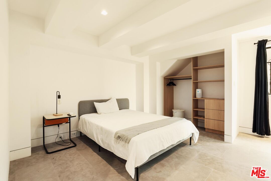 2205 Ocean Front Walk Venice, CA 90291 - Photo 23 of 30 a bedroom with a bed and closet