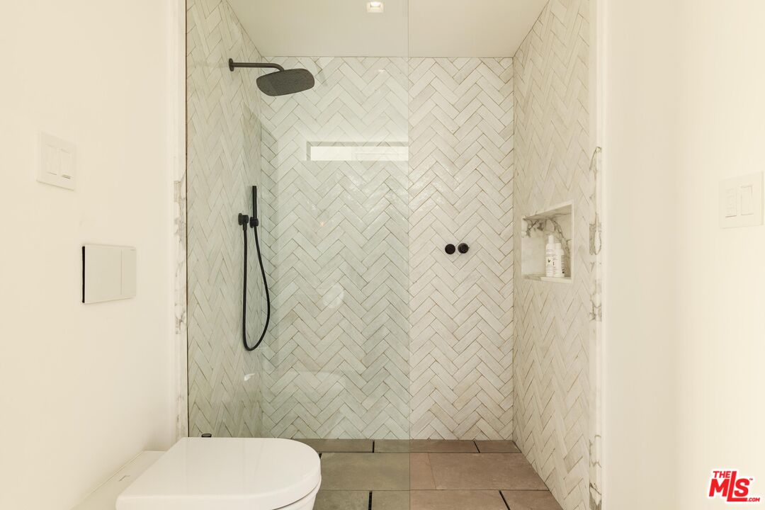 2205 Ocean Front Walk Venice, CA 90291 - Photo 24 of 30 a bathroom with a toilet and a shower