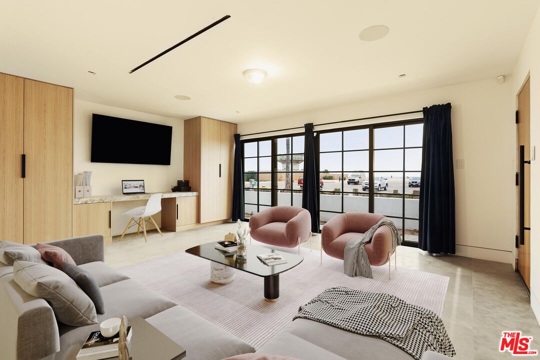 2205 Ocean Front Walk Venice, CA 90291 - Photo 27 of 30 a living room with furniture and a flat screen tv