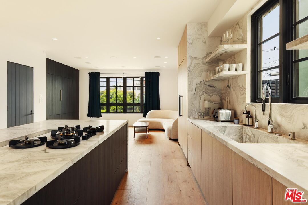 2205 Ocean Front Walk Venice, CA 90291 - Photo 5 of 30 a large white kitchen with a large window