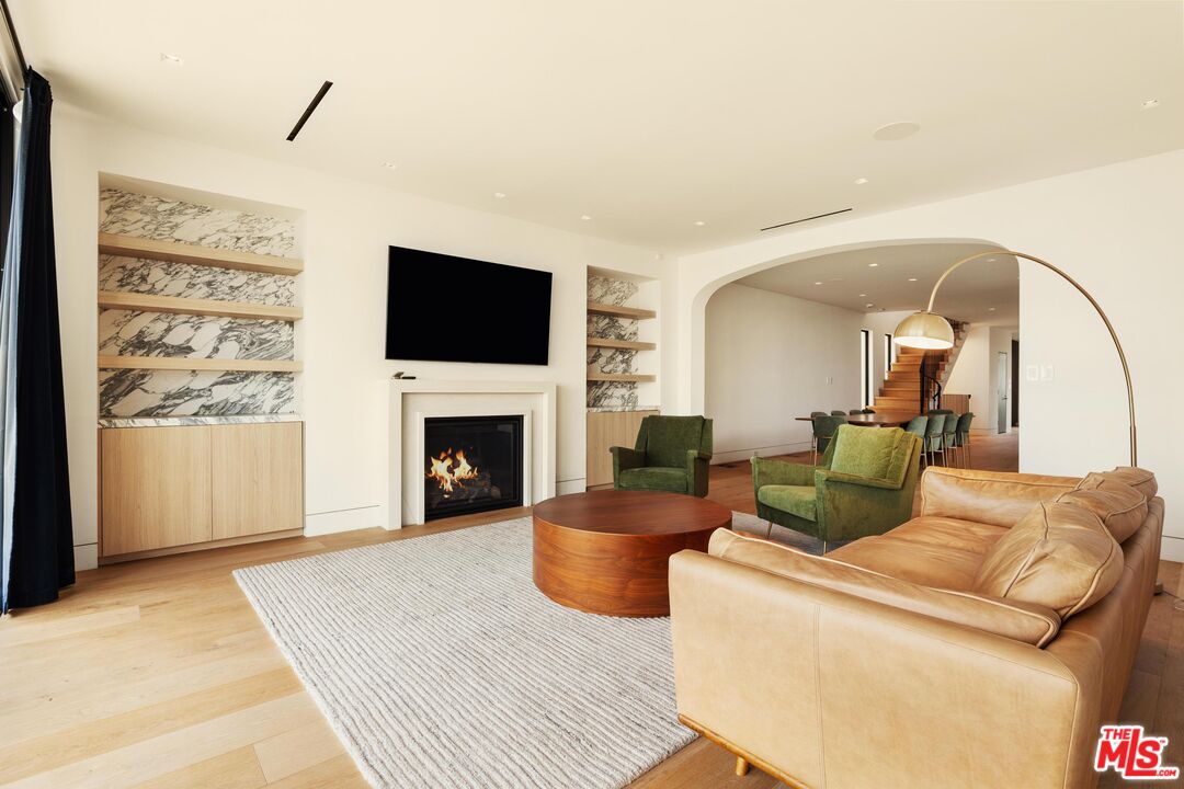 2205 Ocean Front Walk Venice, CA 90291 - Photo 9 of 30 a living room with furniture a flat screen tv and a fireplace