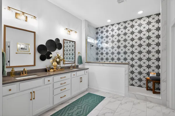 a bathroom with a double vanity sink mirror and shower