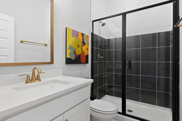 a bathroom with a toilet a sink and shower