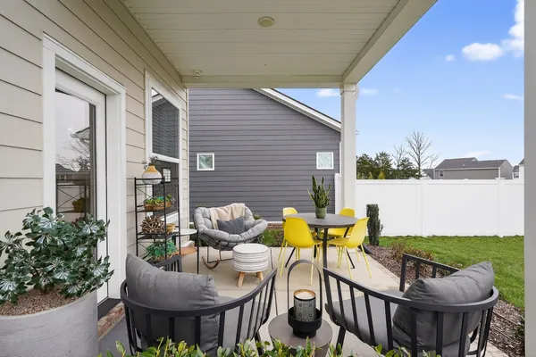 a view of a patio with table and chairs potted plants with wooden floor