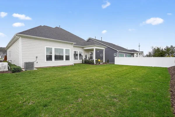 a view of a house with a backyard