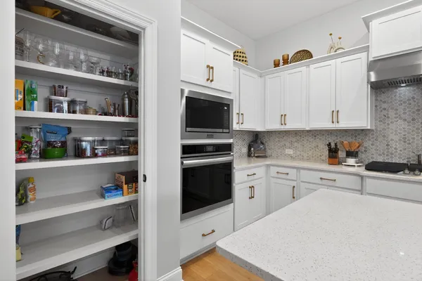 a kitchen with stainless steel appliances cabinets and a window