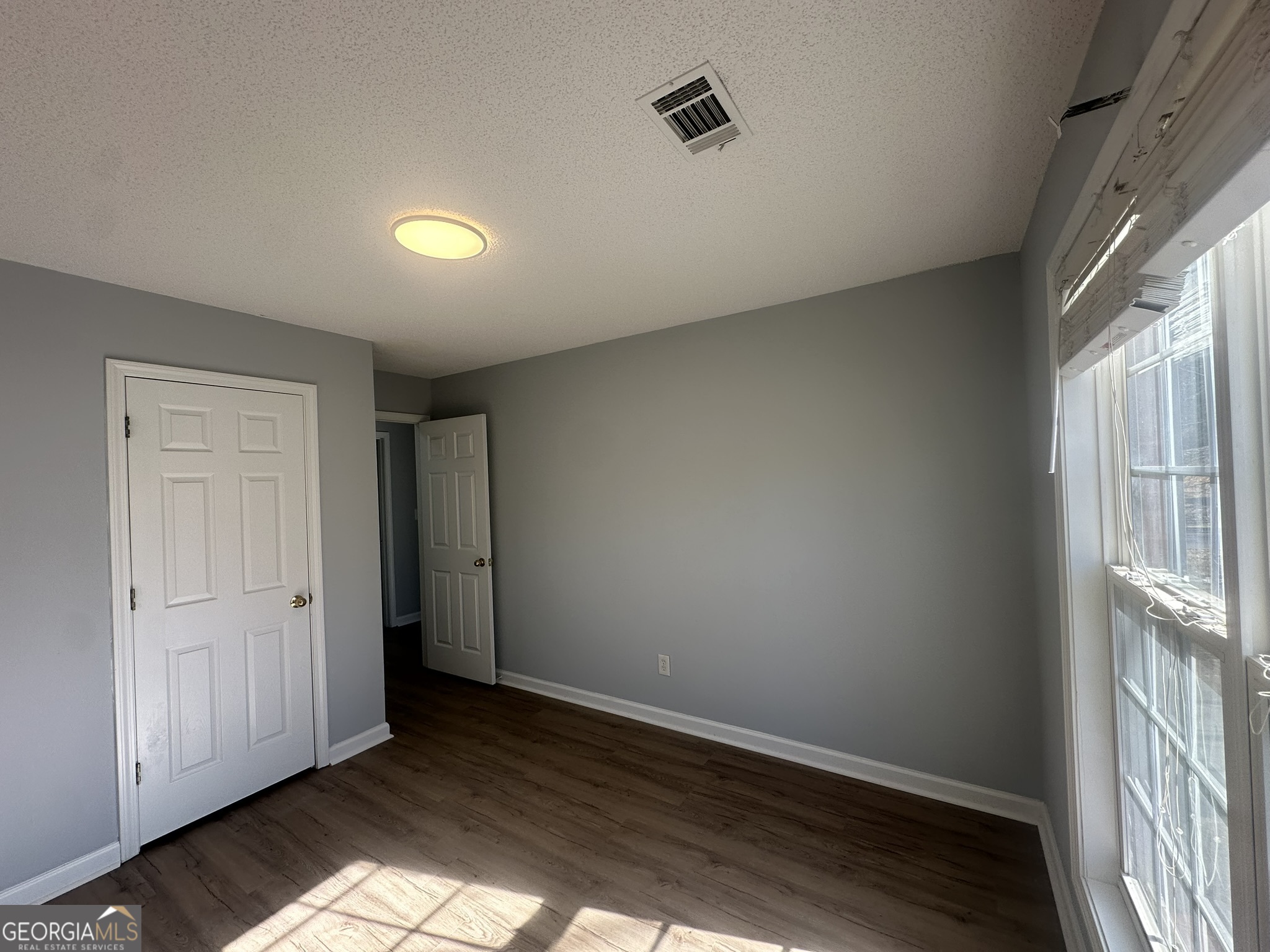 1664 Pinto Trail Jonesboro, GA 30236 - Photo 17 of 31 an empty room with wooden floor and windows