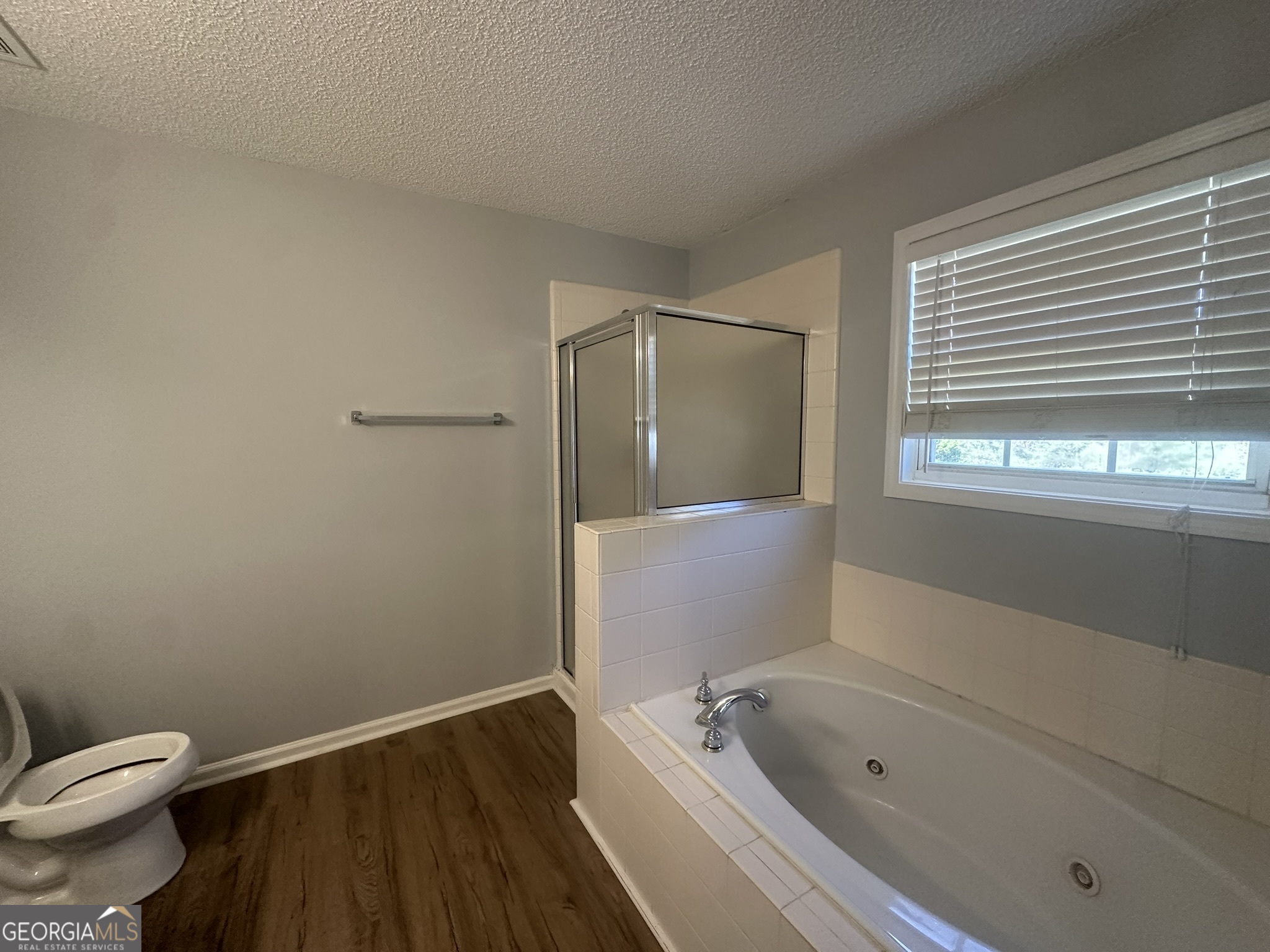 1664 Pinto Trail Jonesboro, GA 30236 - Photo 21 of 31 a bathroom with a toilet and a bathtub