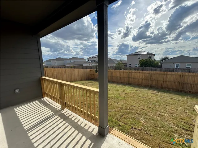 a view of balcony with wooden floor and fence