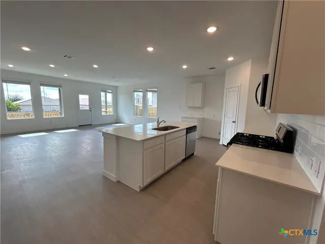 a view of counter top space with kitchen view
