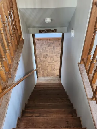 a view of a room with wooden floor and windows