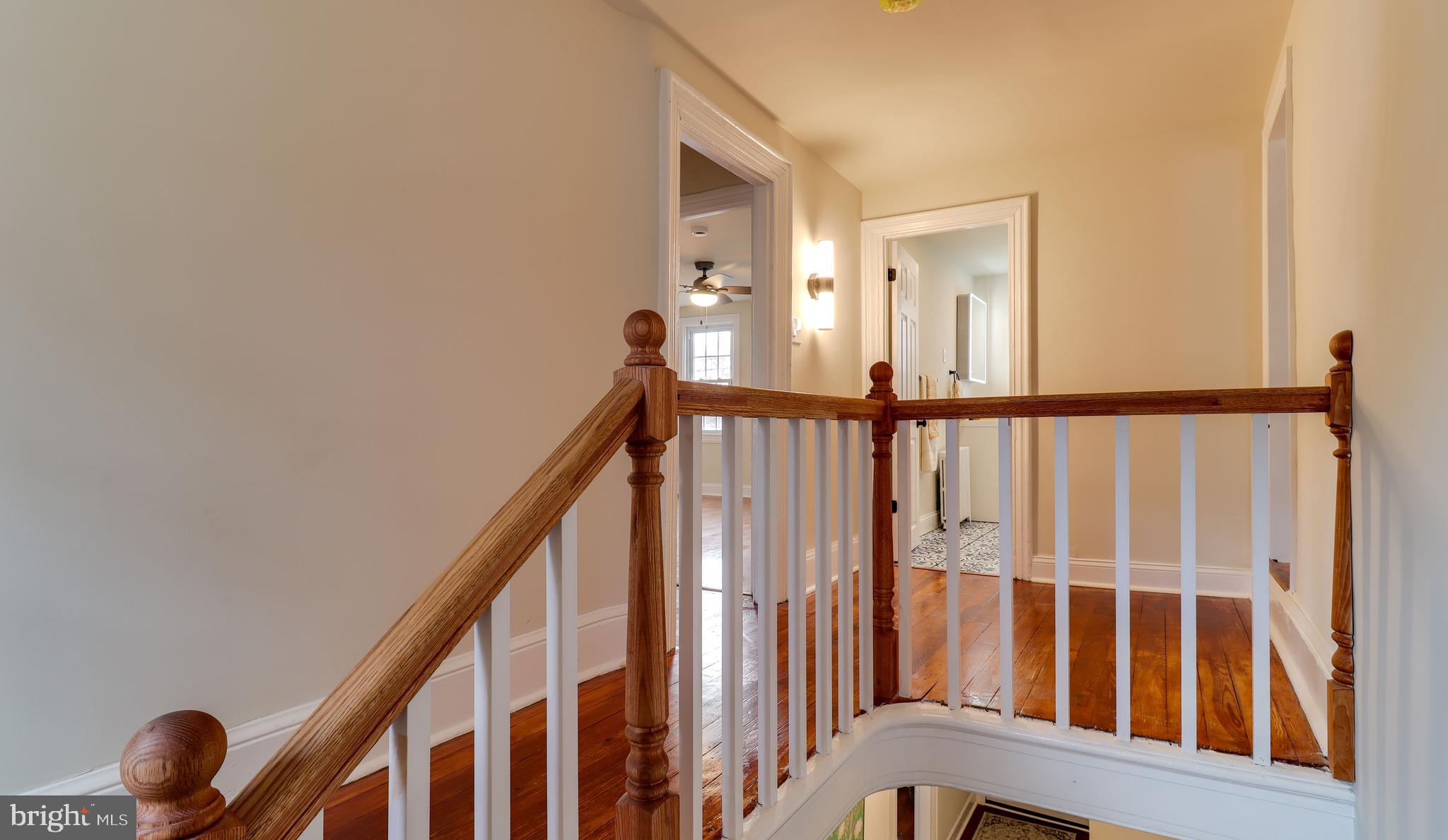 161 Warren Street Beverly, NJ 08010 - Photo 20 of 31 a view of staircase with lots of frames on wall and a window