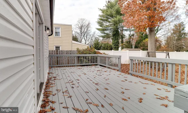 a view of balcony with wooden floor and fence