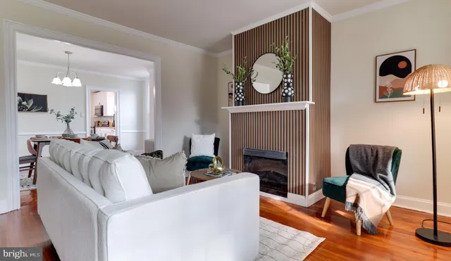 a living room with furniture a fireplace and wooden floor
