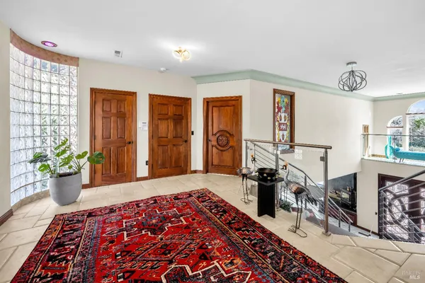 a bedroom with a large bed and wooden floor