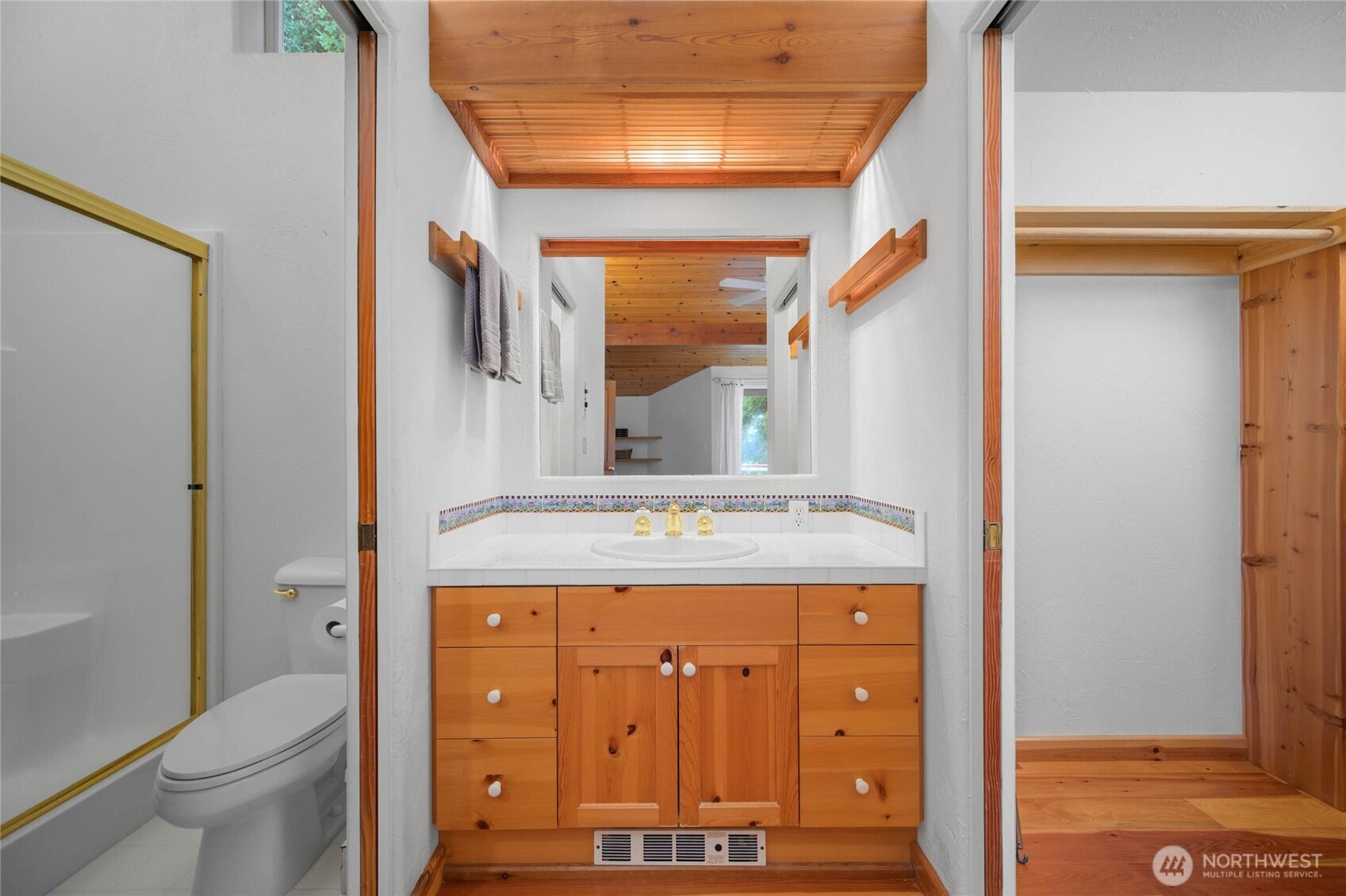 177 Harmon Ranch Hill Road Decatur Island, WA 98221 - Photo 25 of 37 a bathroom with a granite countertop sink a toilet and a mirror