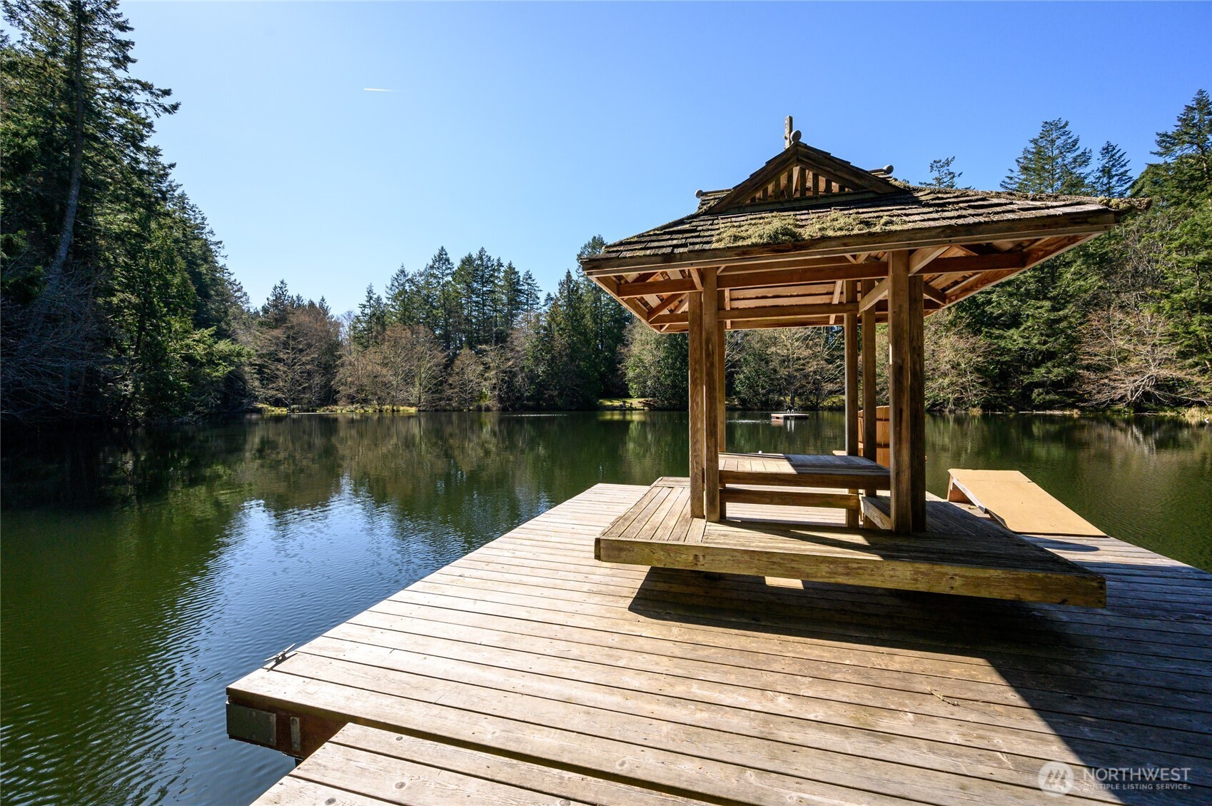 177 Harmon Ranch Hill Road Decatur Island, WA 98221 - Photo 37 of 37 a view of a lake with a table and chairs