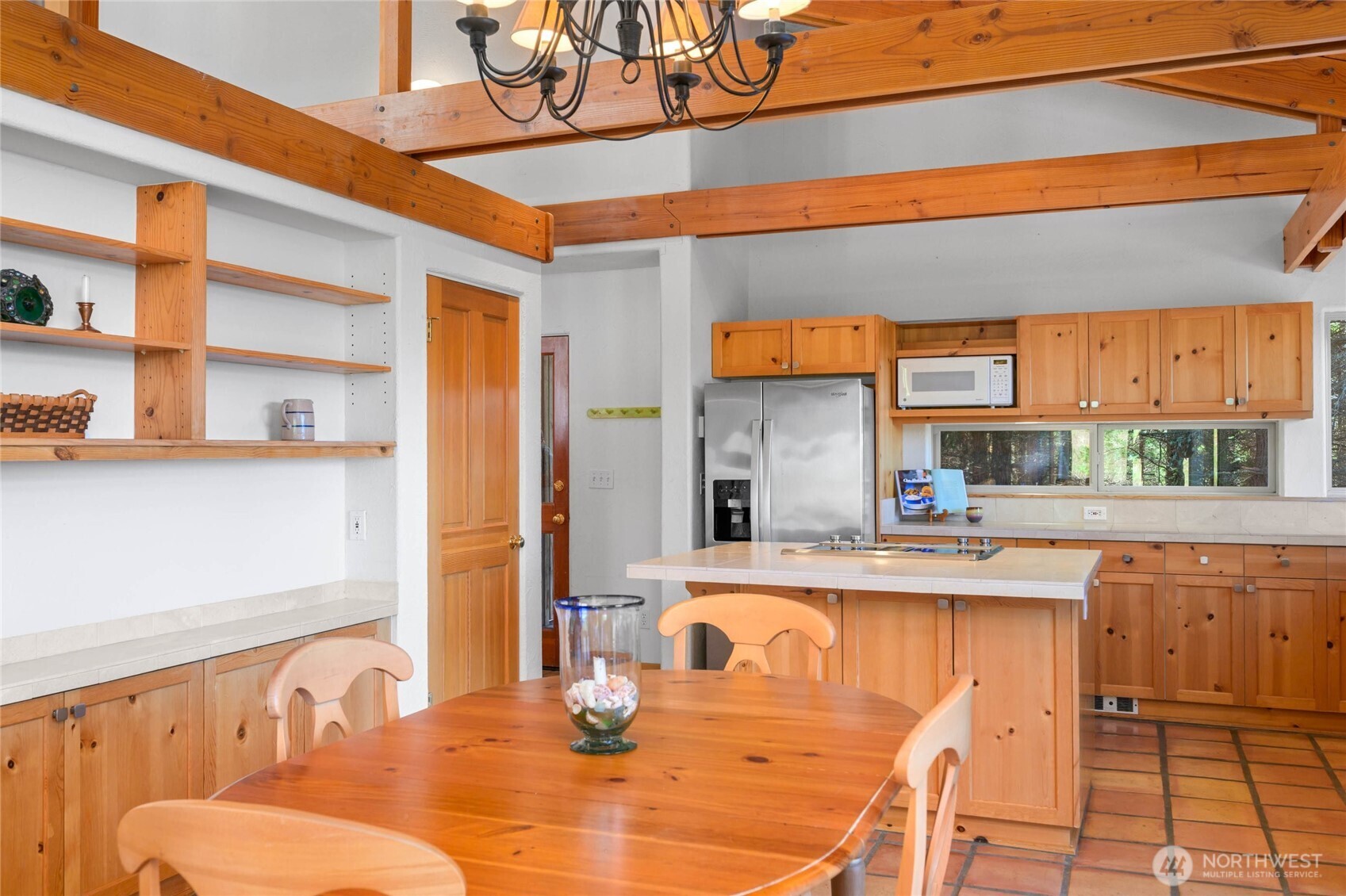 177 Harmon Ranch Hill Road Decatur Island, WA 98221 - Photo 7 of 37 a kitchen with stainless steel appliances kitchen island granite countertop a table and chairs in it