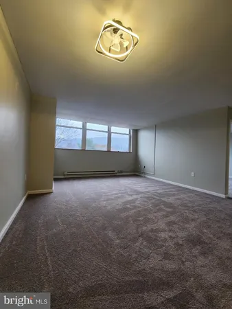 an empty room with a empty space and windows