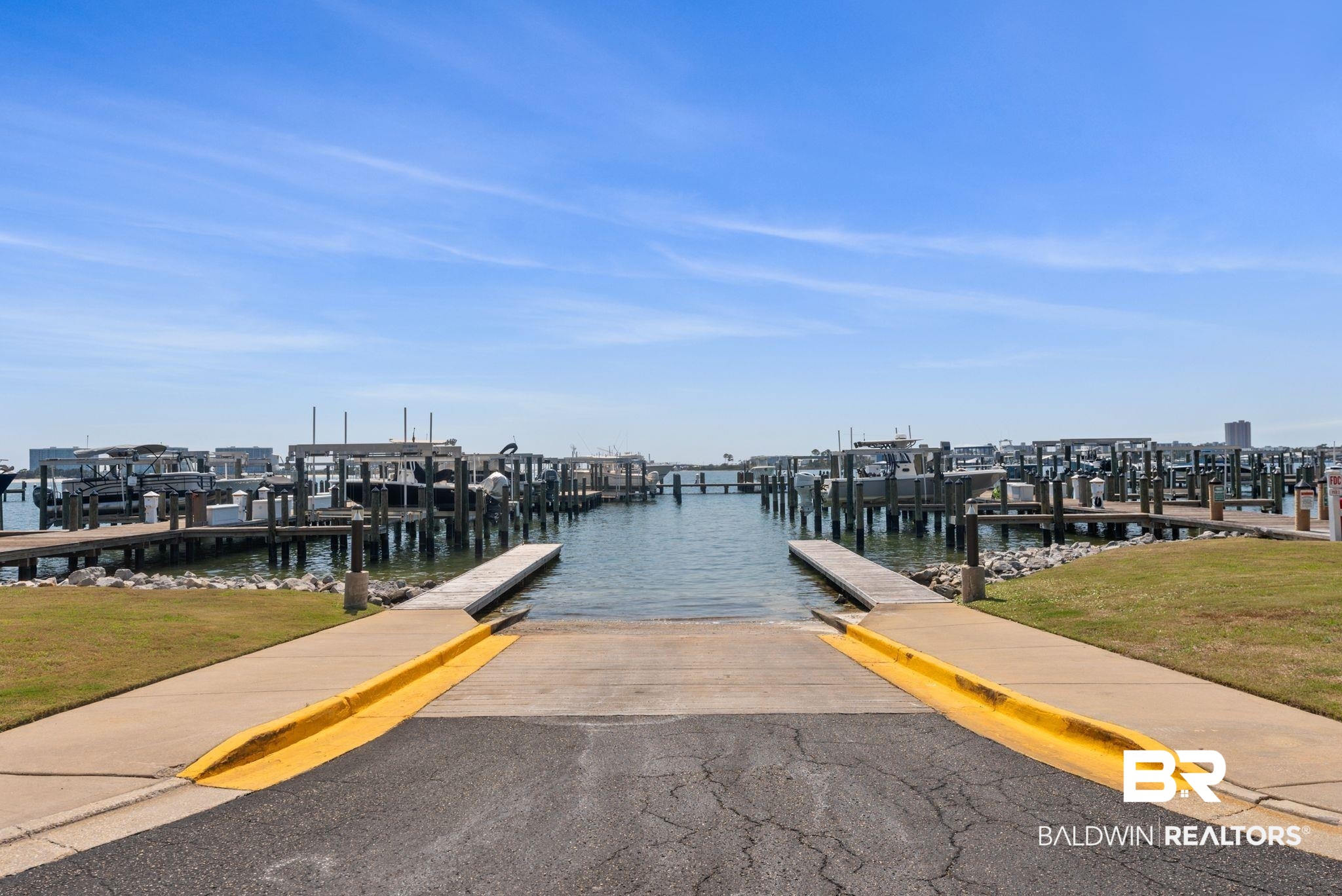 27580 Canal Road, Unit 1233 Orange Beach, AL 36561 - Photo 59 of 79 Dock with a boat ramp, a water view, and a yard