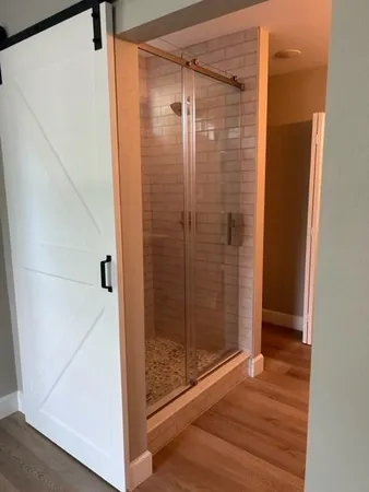 a bathroom with a glass shower door