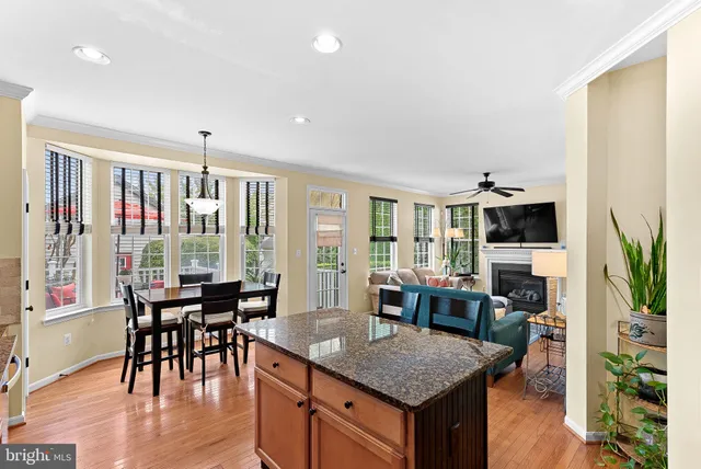 a large kitchen with stainless steel appliances a large counter top a stove a chimney a sink and cabinets