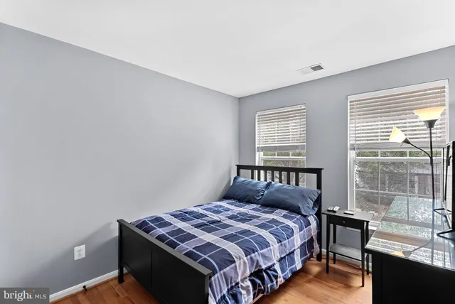 a bedroom with a bed and a rug