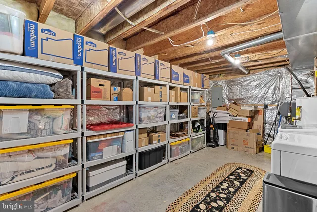 an outdoor sitting area with furniture and umbrella