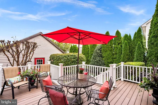 a view of a house with a table and chair under an umbrella
