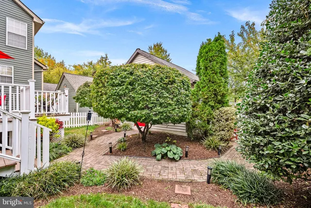 a backyard of a house with fire pit and outdoor seating