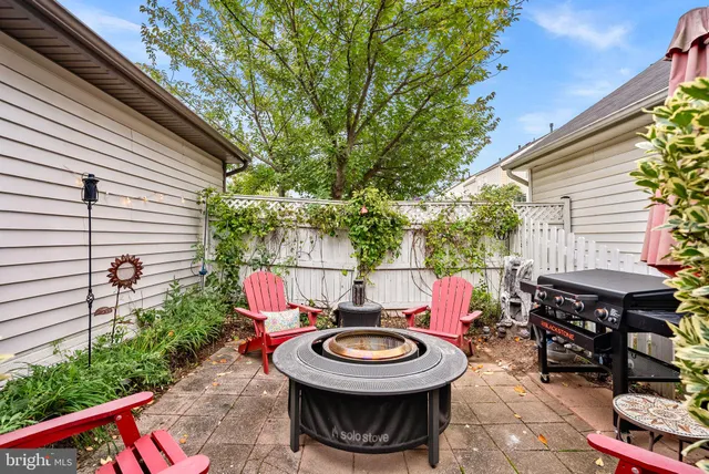 a view of a chairs and table in backyard of the house