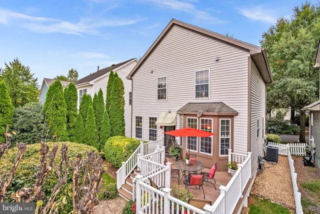 a view of house with outdoor space and sitting area