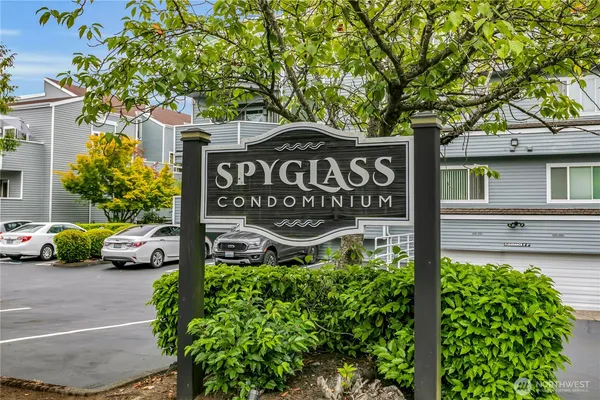 a view of sign board with parked cars