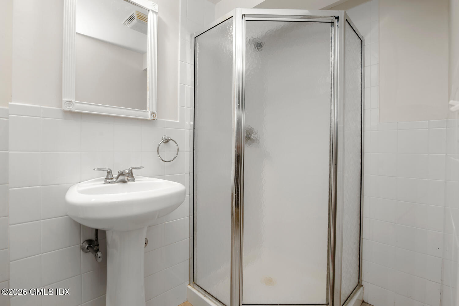 29 Coventry Lane Riverside, CT 06878 - Photo 13 of 20 a bathroom with a sink a mirror and a shower